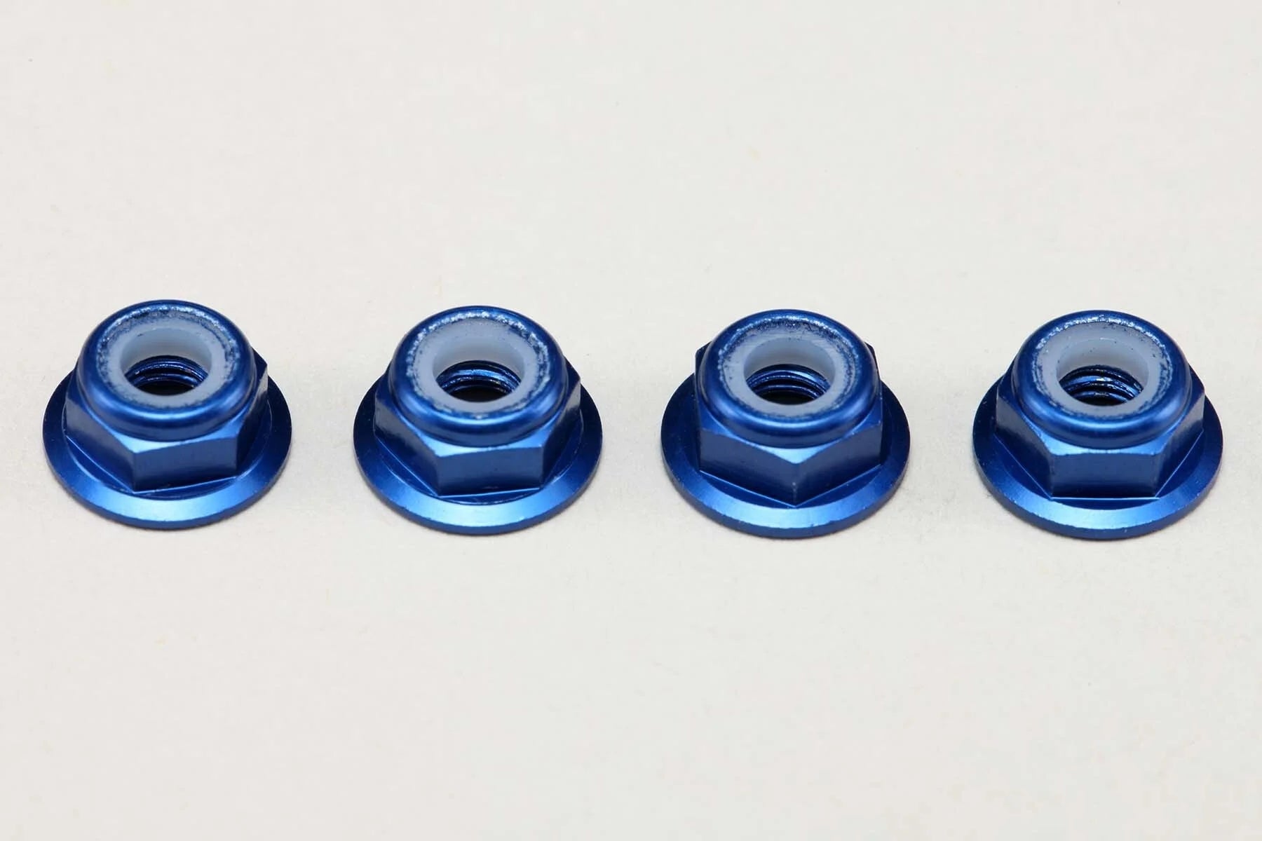 (PO MAY 2026) Yokomo ZC-N4AFLBL Aluminum 4mm Thin Flanged Nylon Lock Nuts / Blue (4pcs) - BanzaiHobby